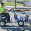 Graco LineLazer 3900 line striping machine, shown with durable construction and ergonomic handles, ideal for precise line marking on parking lots, roads, and sports fields.