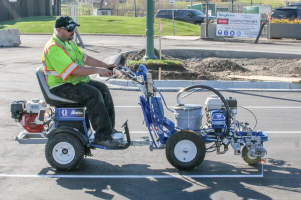 Graco LineLazer 3900 line striping machine, shown with durable construction and ergonomic handles, ideal for precise line marking on parking lots, roads, and sports fields.