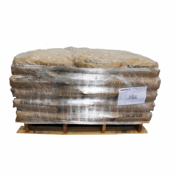 Pallet of SWARCO Illinois Type 1 Glass Beads wrapped in protective stretch film and stacked on a wooden pallet for storage, shipping, and traffic marking applications.
